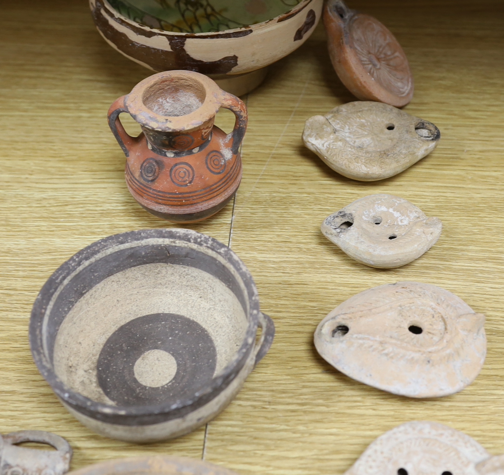 Assorted Cypriot pottery ‘antiquities’, to include bichrome pottery vessels, Cypro-Archaic, c.750-600 BC, Roman terracotta oil lamps, a Byzantine sgraffito ‘phoenix’ bowl, 13th/14th century, 16cm. Provenance - collected
